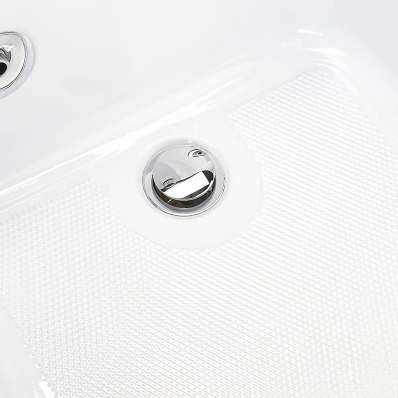 Close-up of a textured, slip-resistant bathing surface with a low-profile drain